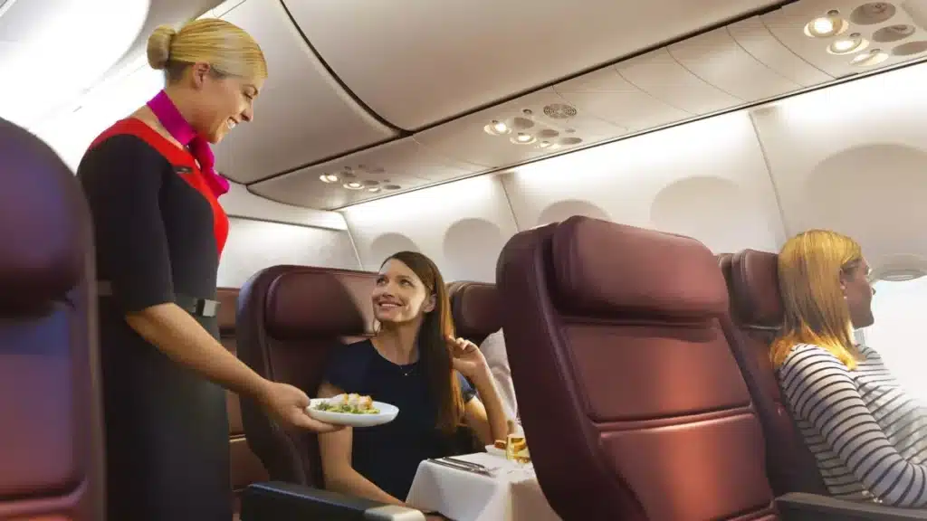 How Much Do Qantas Cabin Crew Earn in 2026? Salary, Benefits & Career Growth 1 Qantas flight attendants in cabin during service